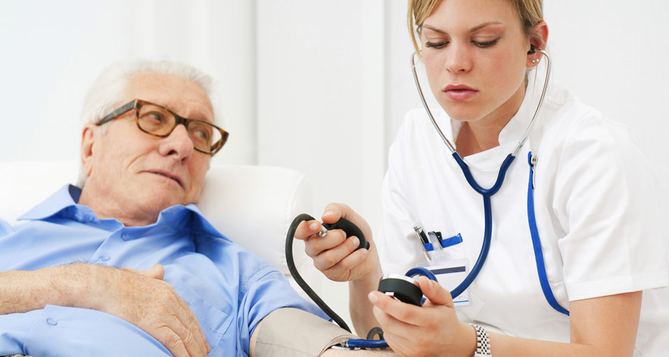 Älterer Mann bei der Blutdruckmessung als Beispiel um einen Schlaganfall zu verhindern